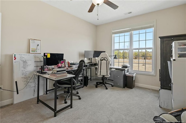 office area with carpet floors, visible vents, baseboards, and a ceiling fan