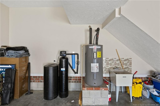 utility room featuring a sink and electric water heater