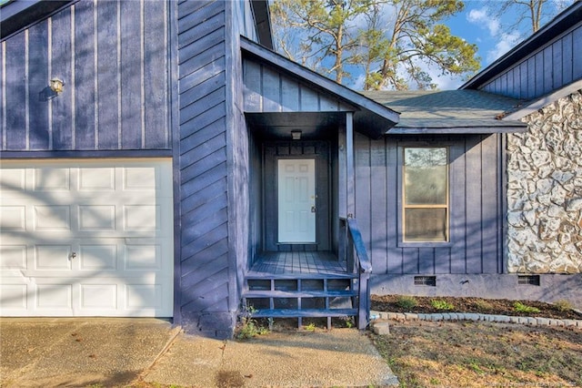 view of exterior entry with a garage, crawl space, and a shingled roof