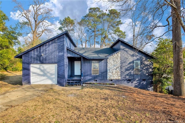 view of front of property featuring concrete driveway, crawl space, and an attached garage