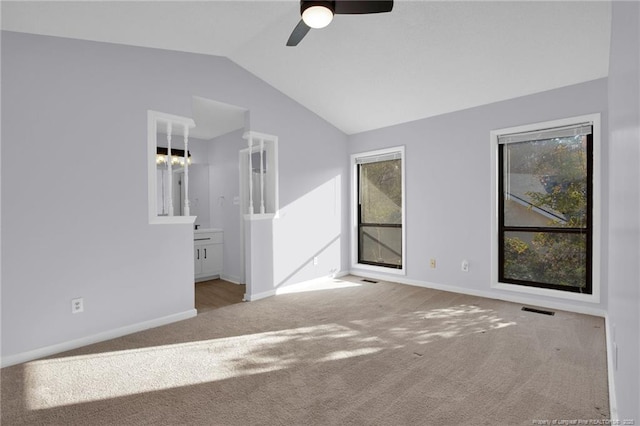 unfurnished bedroom featuring lofted ceiling, carpet, and multiple windows