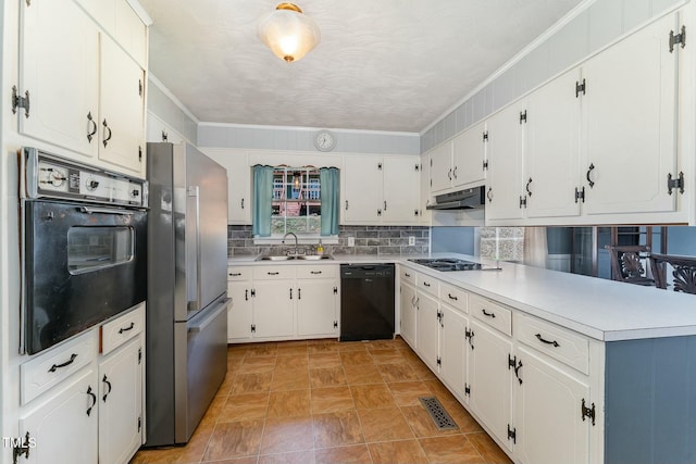 kitchen with under cabinet range hood, visible vents, backsplash, black appliances, and crown molding