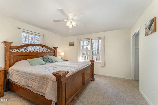 bedroom featuring light carpet, ceiling fan, and baseboards