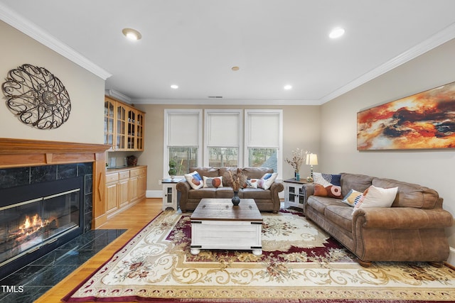 104 Sierra Dr, Chapel Hill, NC 27514 - living area with a tiled fireplace, recessed lighting, wood finished floors, baseboards, and crown molding