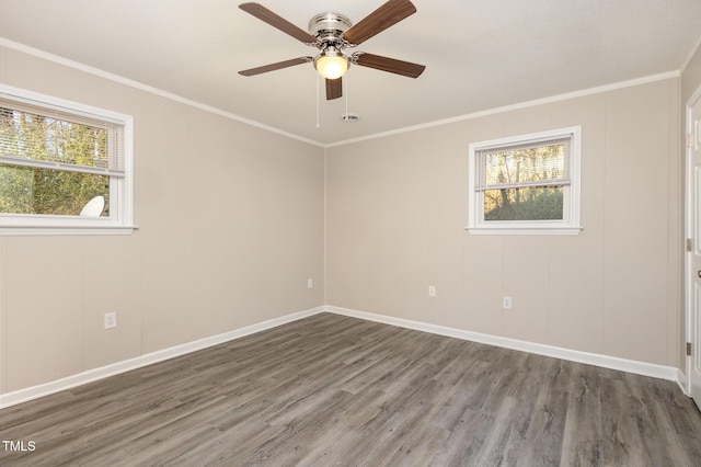 spare room featuring ornamental molding, a ceiling fan, baseboards, and wood finished floors