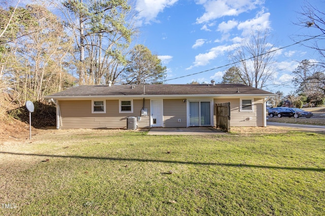 back of house with a lawn, cooling unit, and a patio