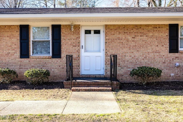 property entrance with brick siding