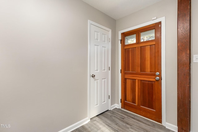 entryway featuring baseboards and light wood-style floors