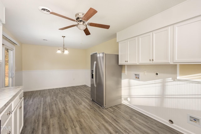 kitchen featuring light countertops, visible vents, white cabinetry, wood finished floors, and stainless steel fridge