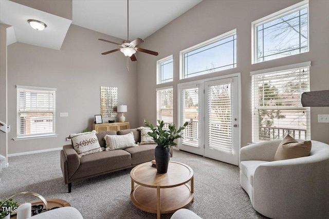 carpeted living area with a towering ceiling and a wealth of natural light