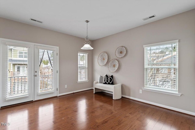 interior space featuring visible vents, wood finished floors, baseboards, and french doors