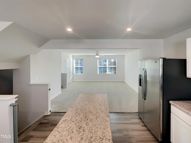 kitchen featuring recessed lighting, baseboards, white cabinetry, and stainless steel fridge with ice dispenser