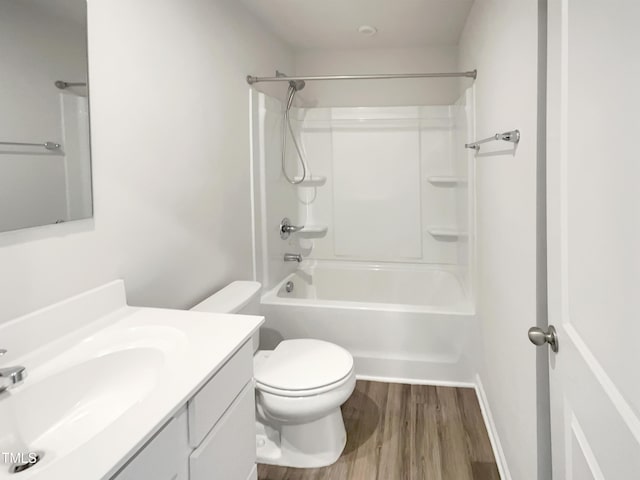 bathroom with toilet, shower / bathtub combination, wood finished floors, and vanity