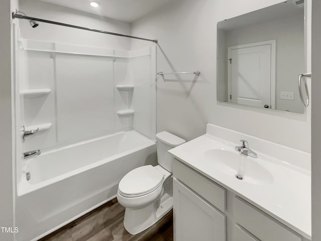 bathroom featuring  shower combination, wood finished floors, vanity, and toilet