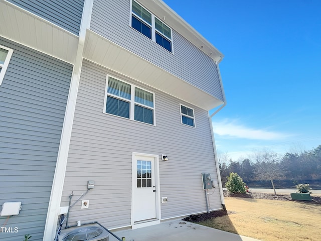 rear view of property featuring cooling unit