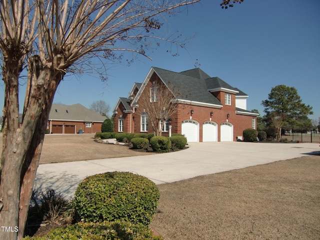 view of side of home featuring concrete driveway and brick siding