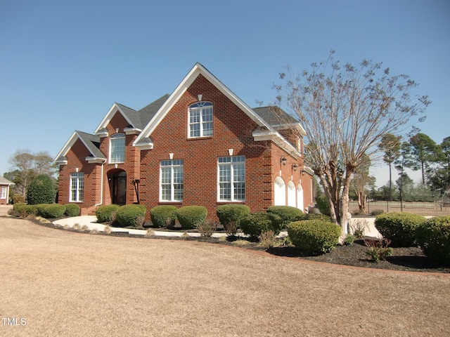 view of front of house with a garage and brick siding