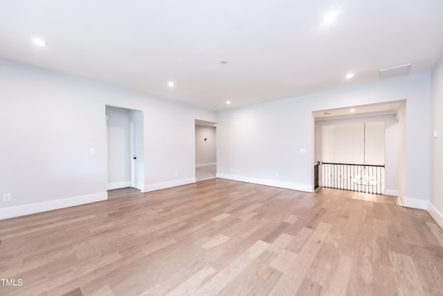 spare room with light wood-style flooring, baseboards, and recessed lighting