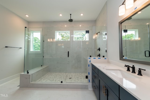 bathroom featuring a healthy amount of sunlight, a shower stall, recessed lighting, and vanity