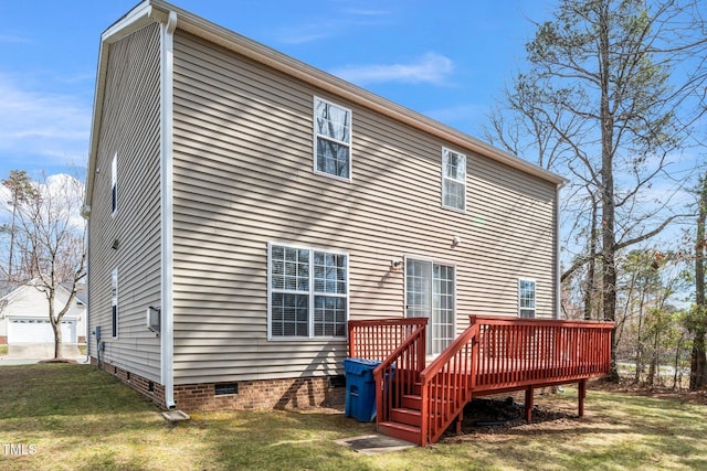 rear view of property featuring crawl space, a lawn, and a deck