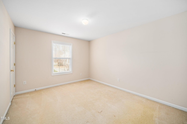 unfurnished room with carpet floors, baseboards, and visible vents