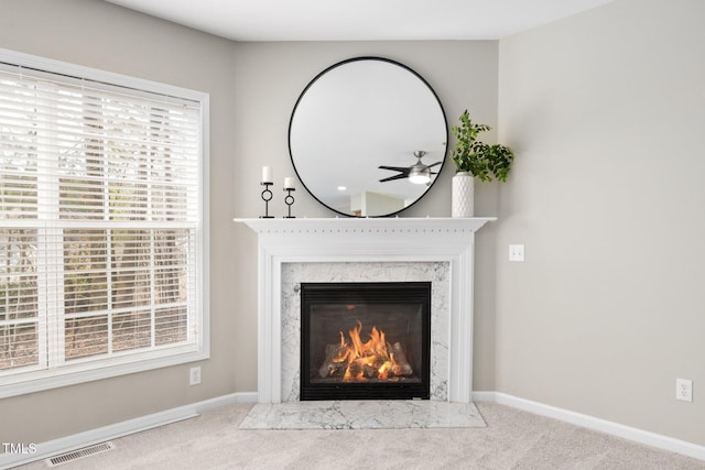 details with a premium fireplace, carpet flooring, visible vents, and baseboards