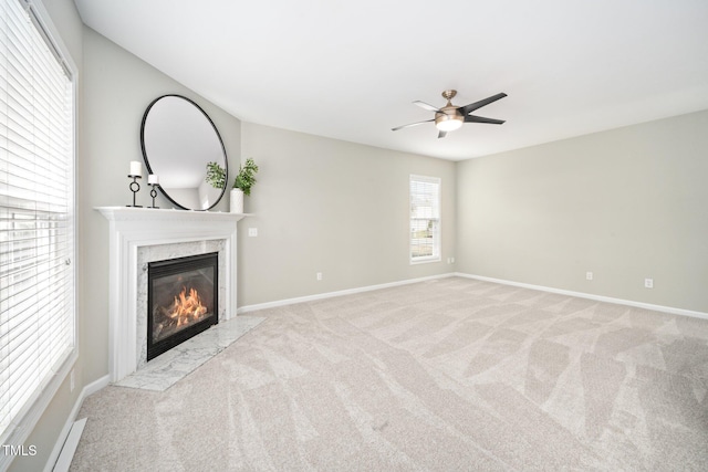 unfurnished living room featuring carpet floors, a fireplace, and baseboards