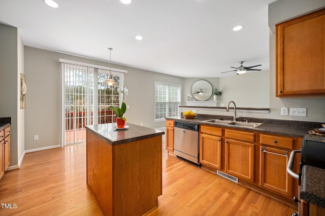 kitchen featuring a sink, light wood finished floors, brown cabinetry, and stainless steel dishwasher