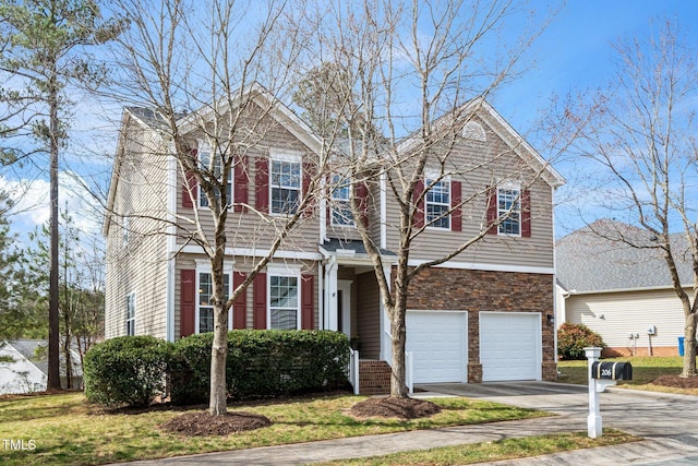 view of front of house featuring concrete driveway and an attached garage