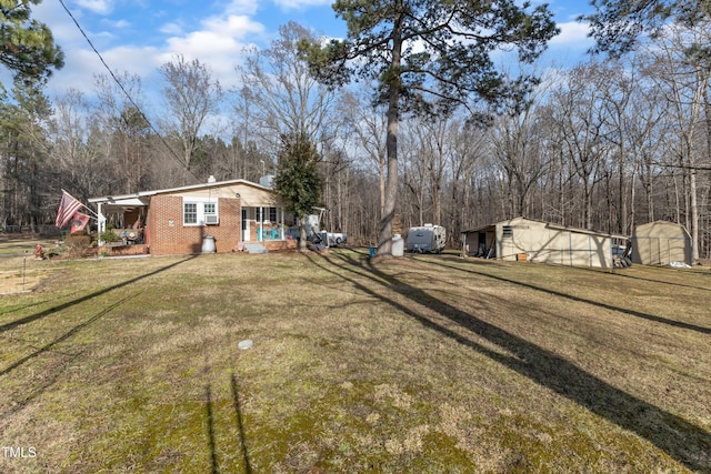 view of yard with a porch and an outdoor structure