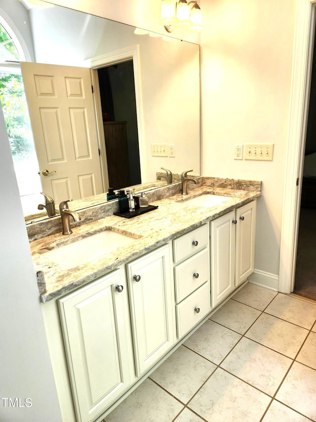 155 Georgetown Woods Dr, Youngsville, NC 27596 - bathroom featuring tile patterned floors, double vanity, and a sink