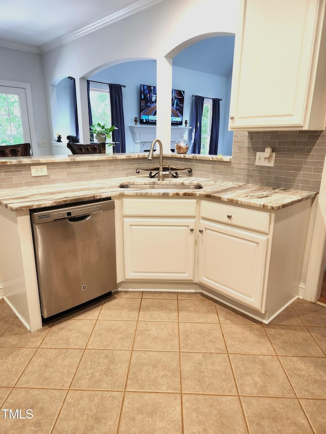 155 Georgetown Woods Dr, Youngsville, NC 27596 - kitchen with light tile patterned floors, tasteful backsplash, a sink, dishwasher, and ornamental molding
