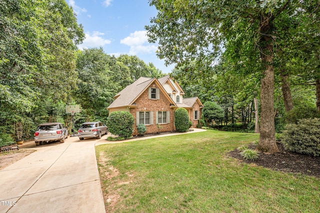 155 Georgetown Woods Dr, Youngsville, NC 27596 - view of front of house with brick siding, concrete driveway, and a front yard