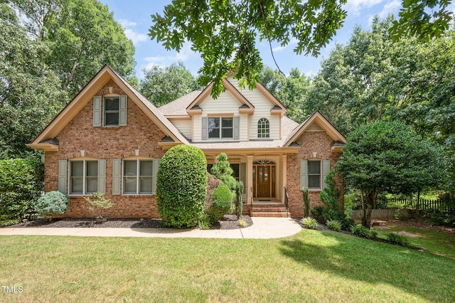 155 Georgetown Woods Dr, Youngsville, NC 27596 - view of front facade featuring brick siding, a front lawn, and roof with shingles