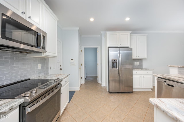 155 Georgetown Woods Dr, Youngsville, NC 27596 - kitchen featuring stainless steel appliances, backsplash, light tile patterned floors, white cabinets, and ornamental molding