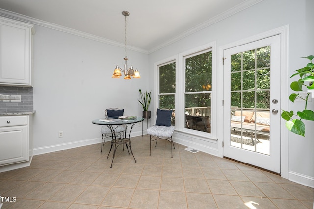 155 Georgetown Woods Dr, Youngsville, NC 27596 - dining area featuring ornamental molding, a chandelier, and light tile patterned floors