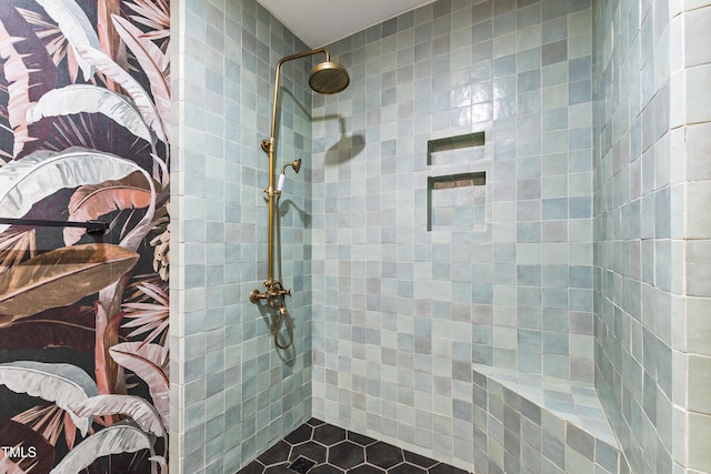 full bath featuring tiled shower