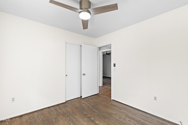 unfurnished bedroom featuring ceiling fan, a closet, and wood finished floors