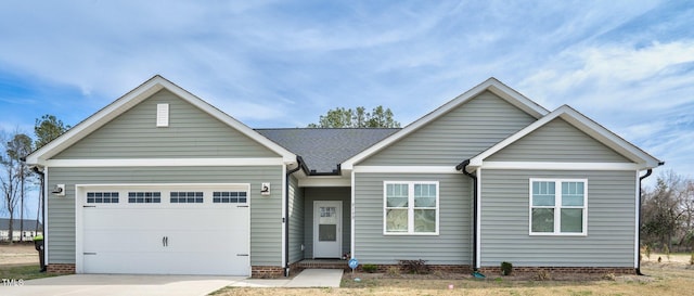 ranch-style house featuring a garage and driveway