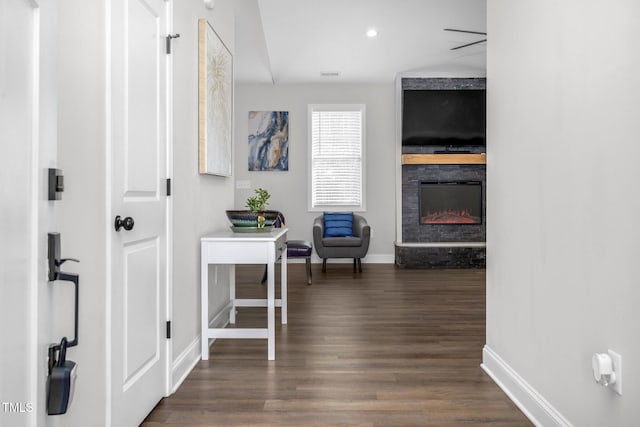 hall with dark wood-style floors, visible vents, baseboards, and recessed lighting