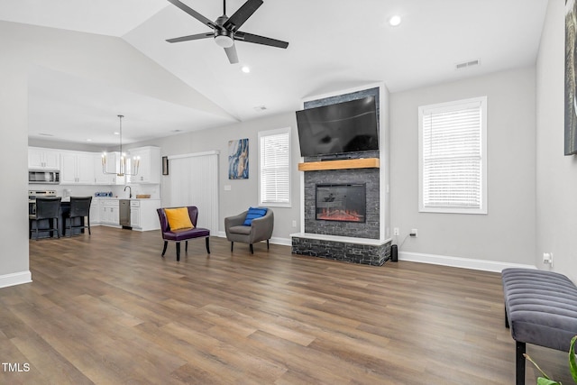 sitting room featuring visible vents, a fireplace, baseboards, and wood finished floors