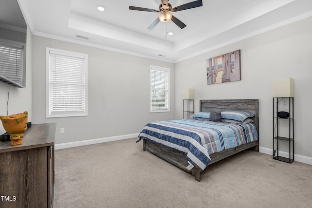 carpeted bedroom with crown molding, a tray ceiling, recessed lighting, and baseboards