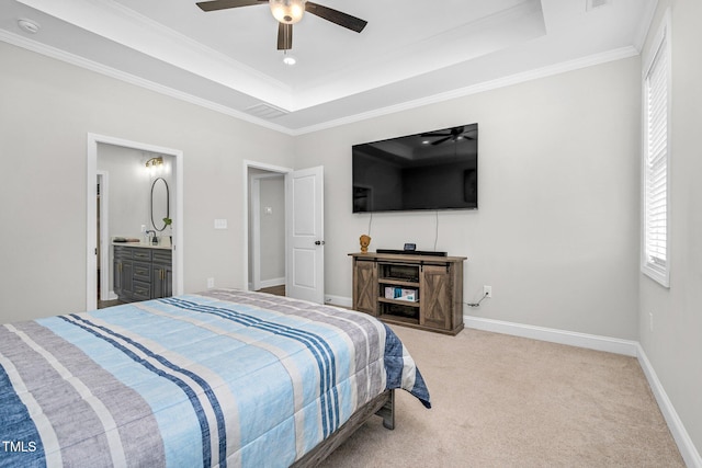 bedroom featuring light carpet, baseboards, a tray ceiling, and crown molding