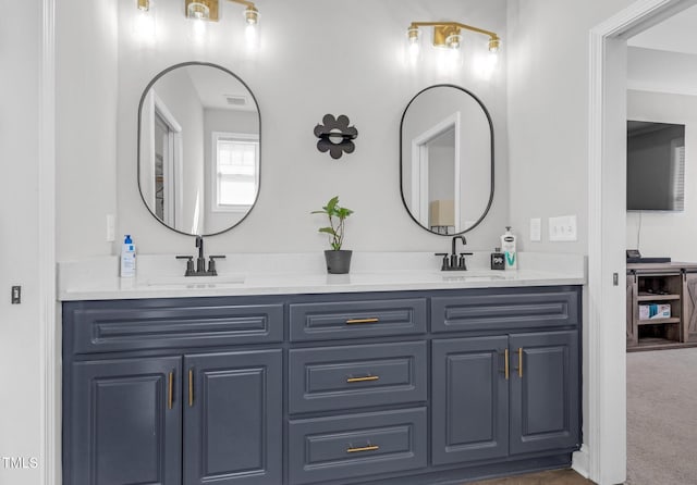 full bath featuring visible vents, a sink, and double vanity