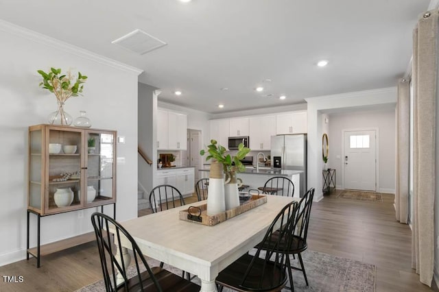 dining space with dark wood-style floors, stairway, recessed lighting, and crown molding