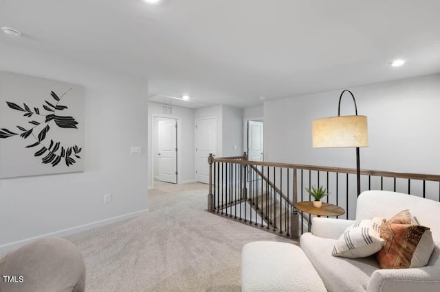 living area with recessed lighting, carpet flooring, an upstairs landing, and baseboards