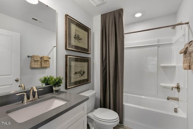 full bathroom with visible vents, shower / tub combo, vanity, and toilet