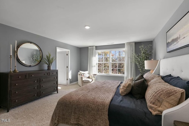 bedroom with light carpet and baseboards