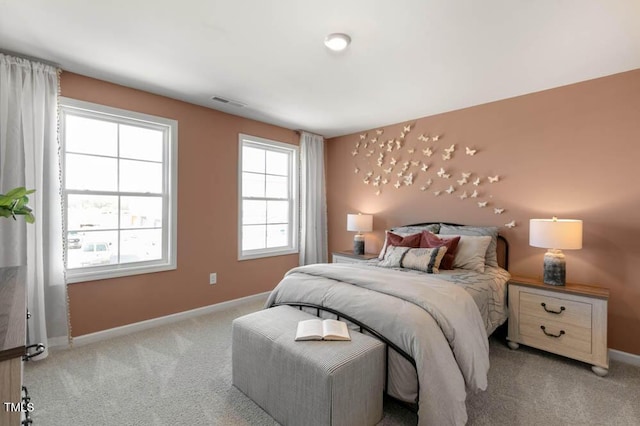 carpeted bedroom featuring visible vents and baseboards