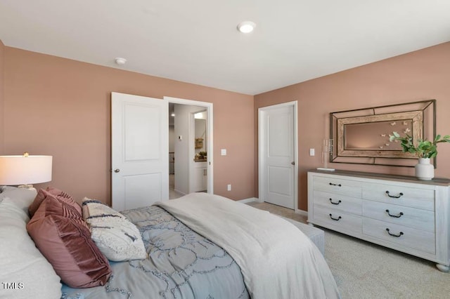 bedroom with baseboards and light colored carpet